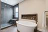 Soaking tub with recessed shelf in wall
