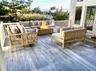 Ai Added furniture. Wooden terrace with an outdoor living space with a fire pit