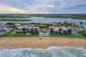 A sweeping ocean-facing view captures the full layout of the development, showcasing both the Atlantic beachfront and lush inland waterways beyond.