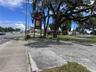 Veiw to the west corner, includes the large concrete stand for a sign, and the existing signage on corner next to oak trees this veiw is of Hwy 41 and