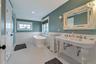 Bathroom with tile patterned floors and plus walk in shower