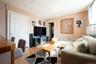 Living room with a paneled ceiling and light wood-type flooring