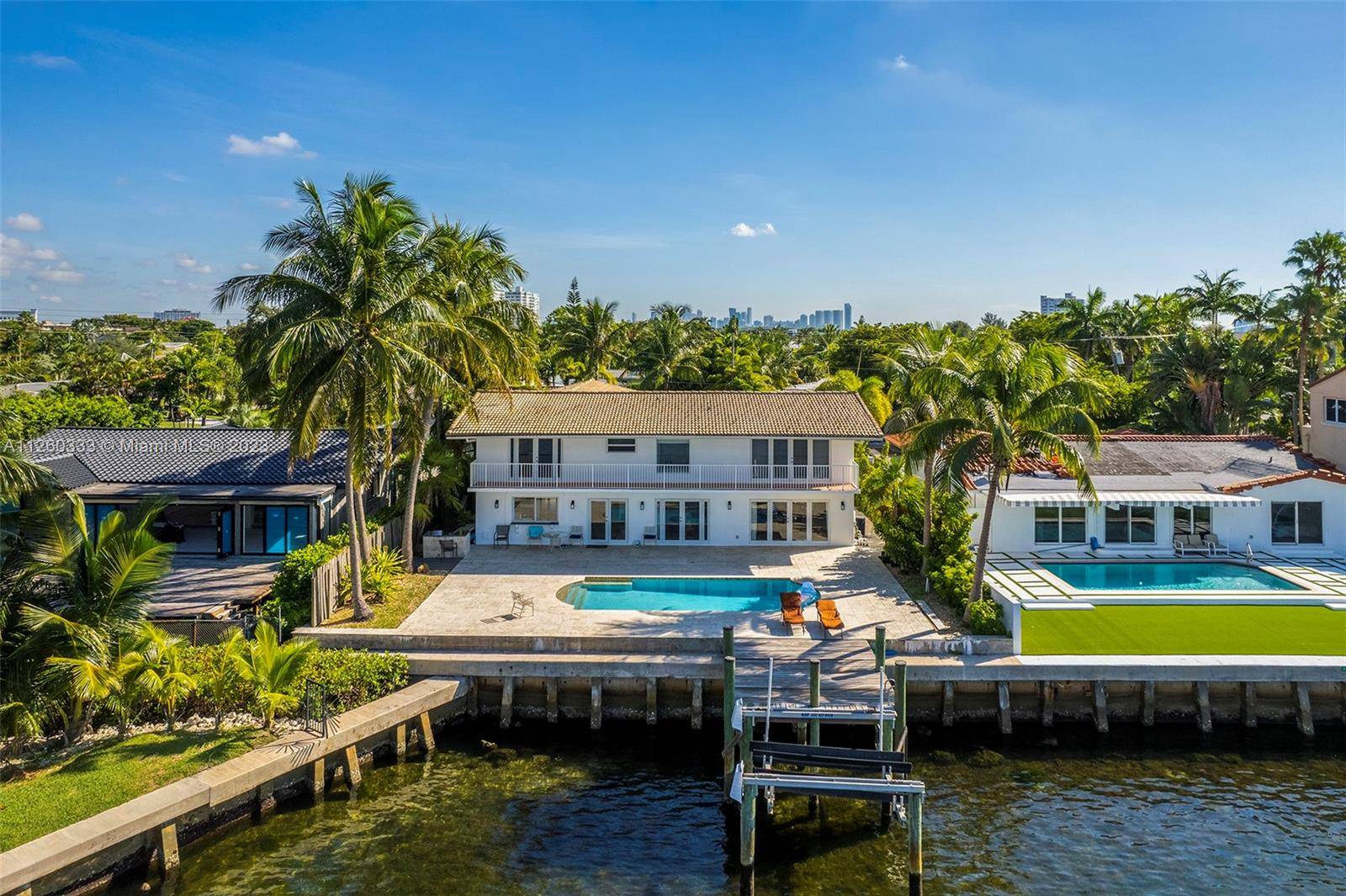 Two story elegant bayfront mansion, built in 1968 featuring high ceilings, formal floor plan, great custom built office, large family room, high impact resistant glass doors and windows, major upgrades ...