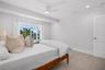 Bedroom 2 with sliding doors to the pool deck