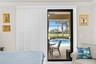 Primary Bedroom Featuring Sliding Glass Doors and Custom Shutters