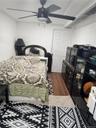 Bedroom featuring wood finished floors and ceiling fan