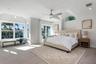 Primary bedroom with waterviews and sliding doors to the outside patio