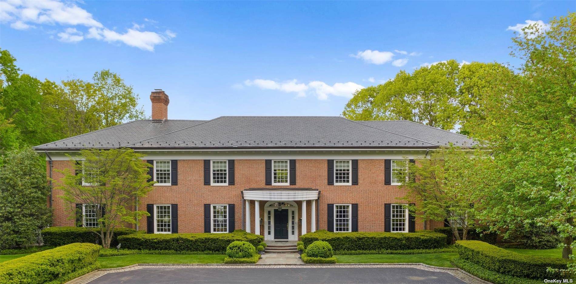 This exceptional 8 bedroom brick Colonial residence is set on 8.