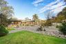 View of grassy yard featuring a patio area