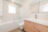 Full bath with enclosed tub / shower combo and vanity