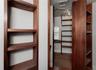 Record room or library with built-in wooden shelves & two built-in desks.