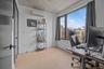 Office space with light wood-style floors and a wall mounted air conditioner