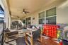 Private screen enclosed pool and hot tub with projector screen, outdoor dining, and lounge area.
