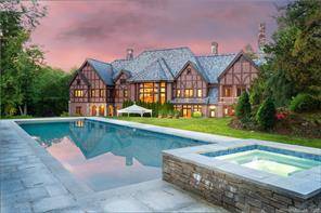 Exceptional stone and brick manor, with beautiful architectural detail, is sited high on a hill overlooking a breathtaking pond and 4 park like acres.