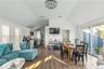 Living room featuring hardwood / wood-style flooring, lofted ceiling, and sink