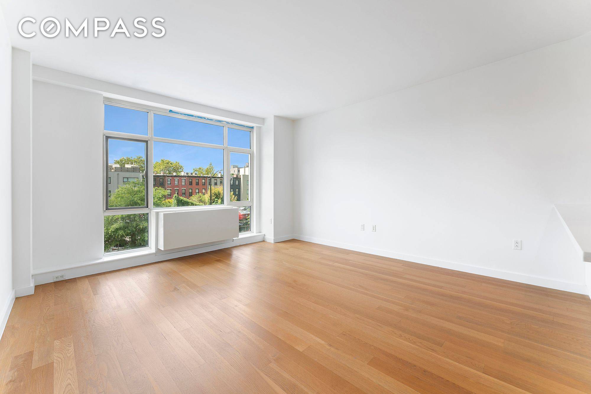 Floor to ceiling windows and wide plank hardwood floors greet you as you enter the south facing unit.