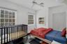Bedroom featuring a ceiling fan and baseboards