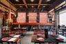 Wine room featuring beam ceiling
