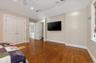 Oversized Bedroom featuring dark wood-style floors, a ceiling fan, large closet, and ensuite bathroom