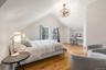 Bedroom with light wood-style floors, lofted ceiling, a chandelier, baseboards, and a desk