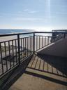 Balcony with view of water and beach