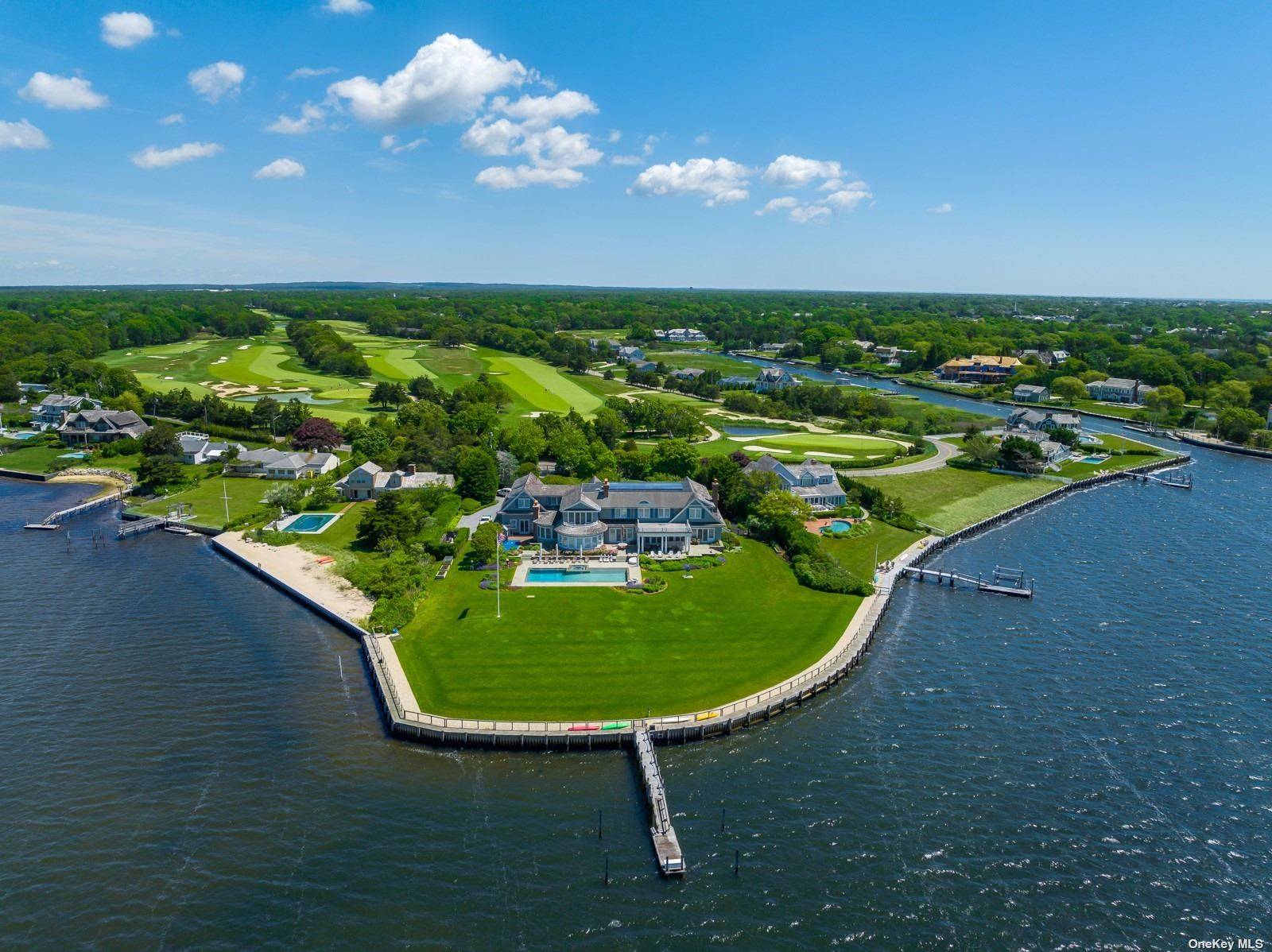 Introducing The Point, an exquisite waterfront estate situated on 2 acres with 380 feet of frontage on Moriches Bay, a private dock and separate carriage house.