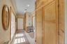 Foyer Hallway with extensive built-in wooden cabinetry, recessed lighting, and tile flooring.