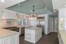 Spacious Kitchen with Buffet Bar to Dining Room and Service Bar, w/ room for seating family and guess, facing Living Room.