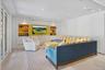 Living area featuring ornamental molding, recessed lighting, built in shelves, light wood-style floors, and a decorative wall