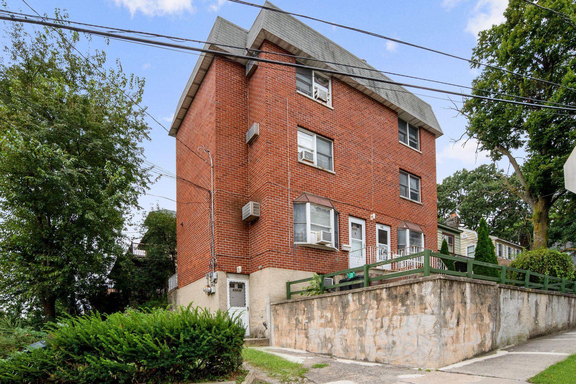 Large brick two family house on corner lot features two triplex apartments each with three bedrooms, two full and one half bath and open kitchen, dining and living room.