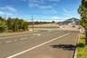 View of road with curbs, sidewalks, and traffic signs