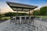 Patio terrace at dusk featuring a ceiling fan, a yard, a patio, and an outdoor kitchen