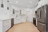 Kitchen with light wood-style floors, stainless steel appliances, backsplash, a peninsula, and recessed lighting