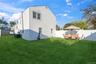 Rear view of house featuring a fenced backyard