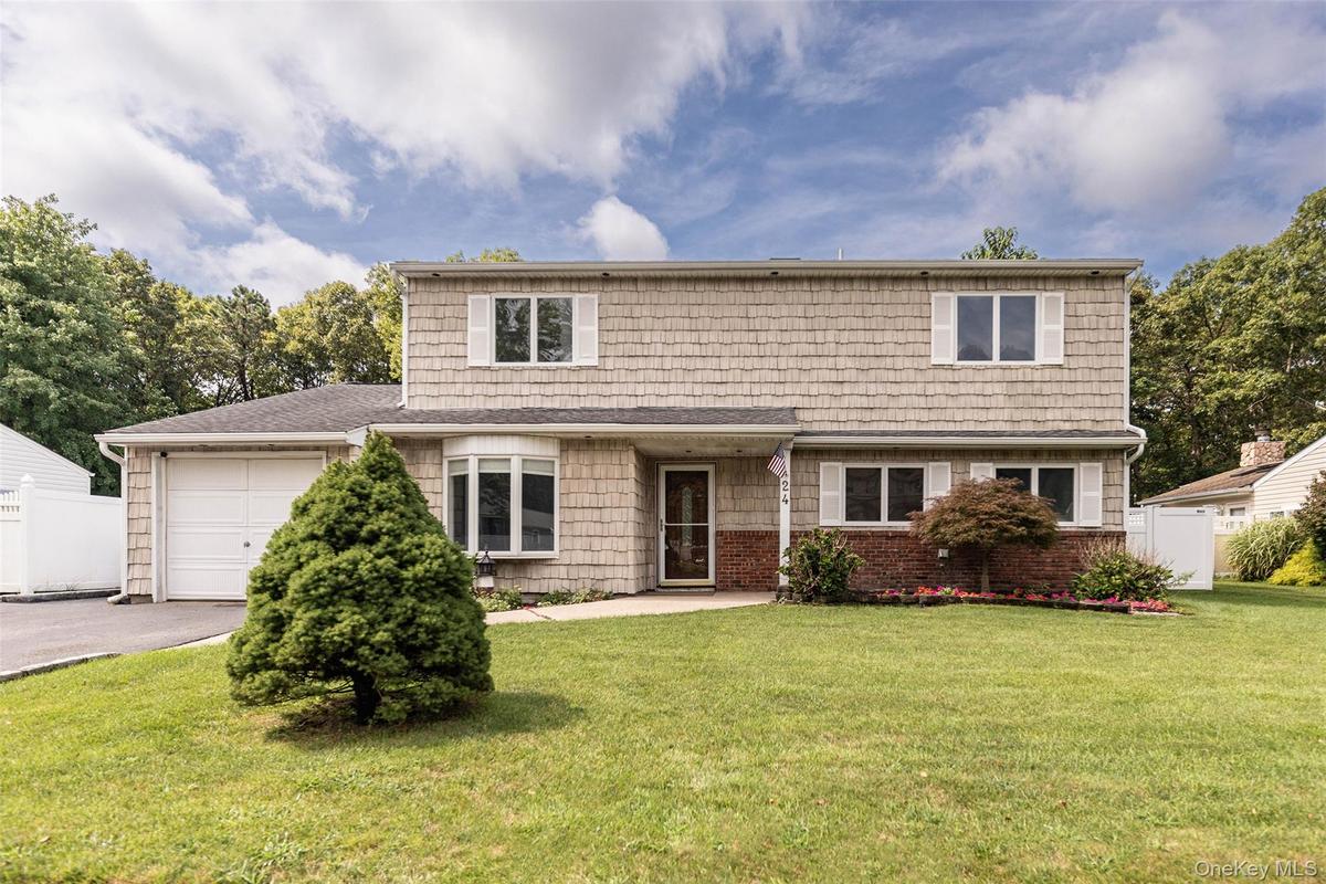 5 Bedroom 2.5 Bath Colonial with wide apron and driveway for extra parking.