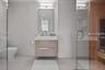 Bathroom featuring tile patterned floors, toilet, vanity, a shower with shower door, and tile walls