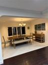Dining room with a notable chandelier, ornamental molding, arched walkways, light wood finished floors, and baseboards