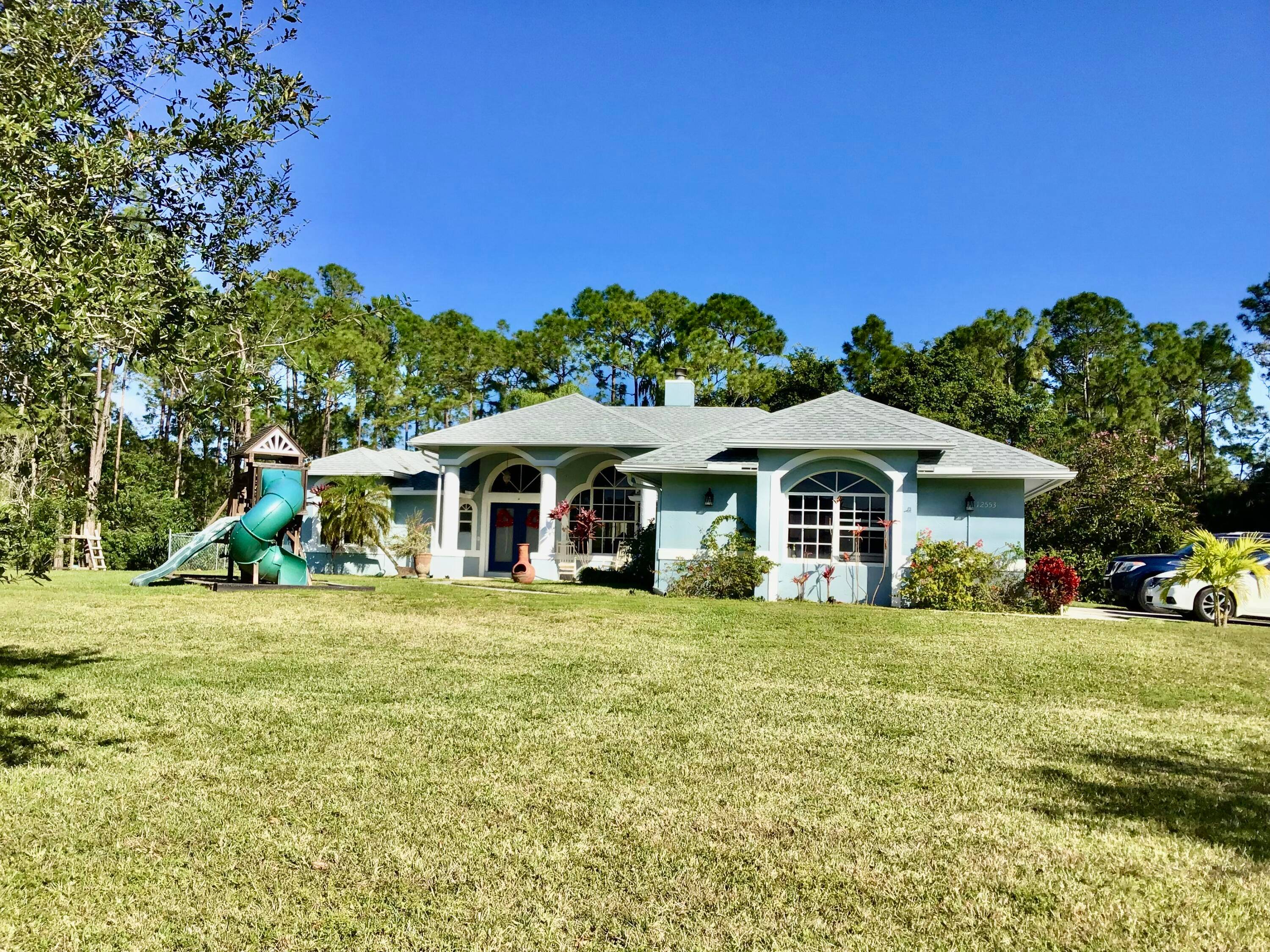 Just in time for 2024 ! Gorgeous home sitting on over 1 acre located in the acreage, FL FOR SALE !