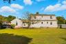 Rear view of property featuring a fenced backyard and a chimney