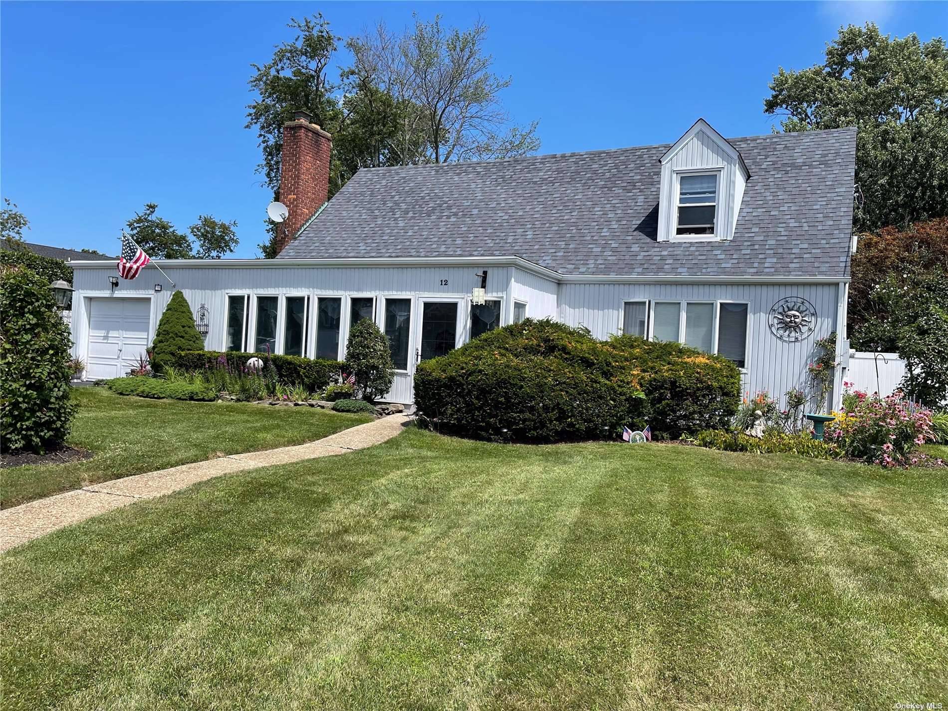 Charming and spacious 1940's unique Cape Cod with enclosed front porch and over sized parklike grounds.