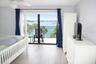 Primary Bedroom with entrance to balcony.