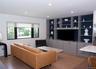 Living room with light wood-type flooring and recessed lighting