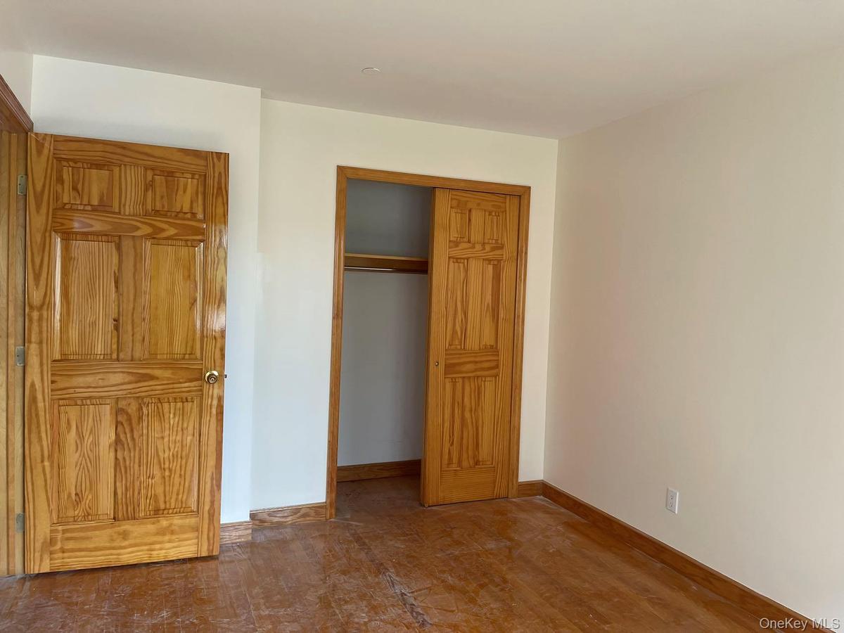 Unfurnished bedroom featuring a closet and baseboards