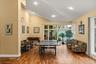 Spacious entertainment room featuring wood-finish flooring and a high vaulted ceiling