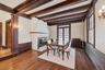 Dining area featuring radiator, dark wood finished floors, a fireplace, french doors, and ornamental molding