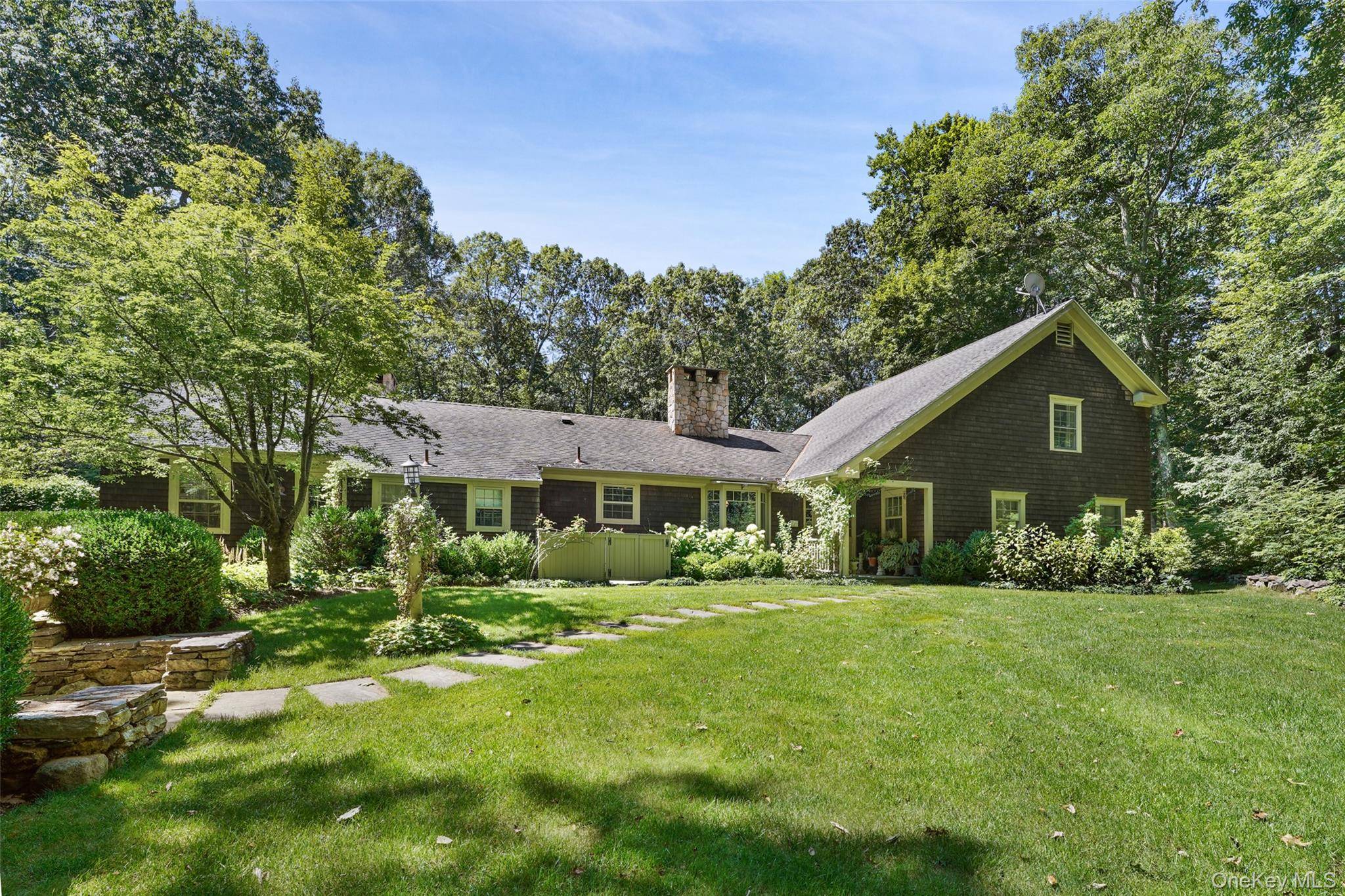 Charming converted contemporary farm ranch with a spectacular stone terrace and back yard.