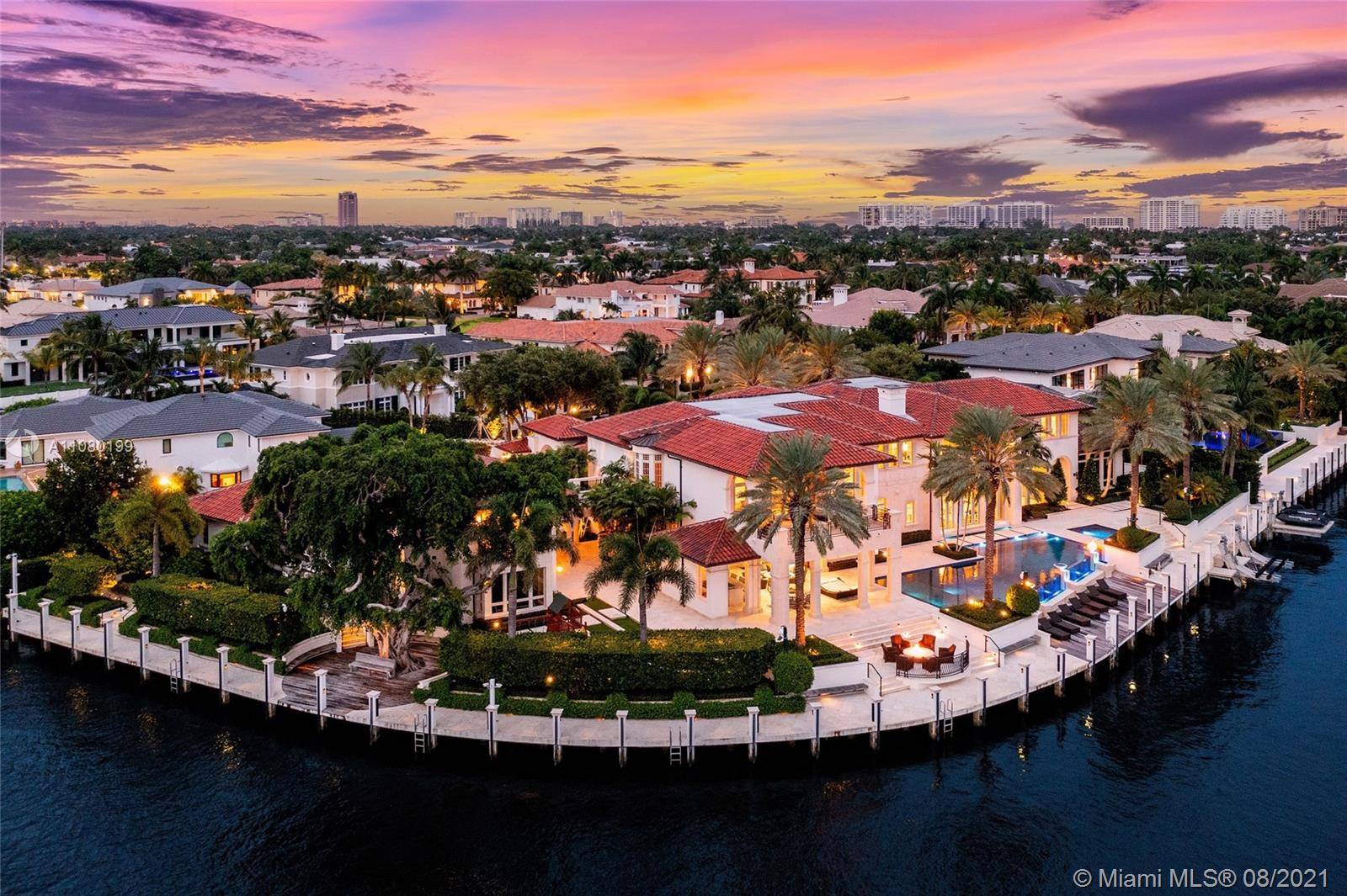 Step inside this one of a kind waterfront point lot located in Royal Palm Yacht Country Club.