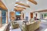Living Room with vaulted ceilings with exposed wood beams, skylights, and recessed lighting. Open to the Family Room