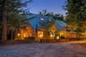 As evening falls, the restored post-and-beam barn takes on an inviting warmth, beautifully illuminated from within