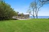 View of green lawn with a water view